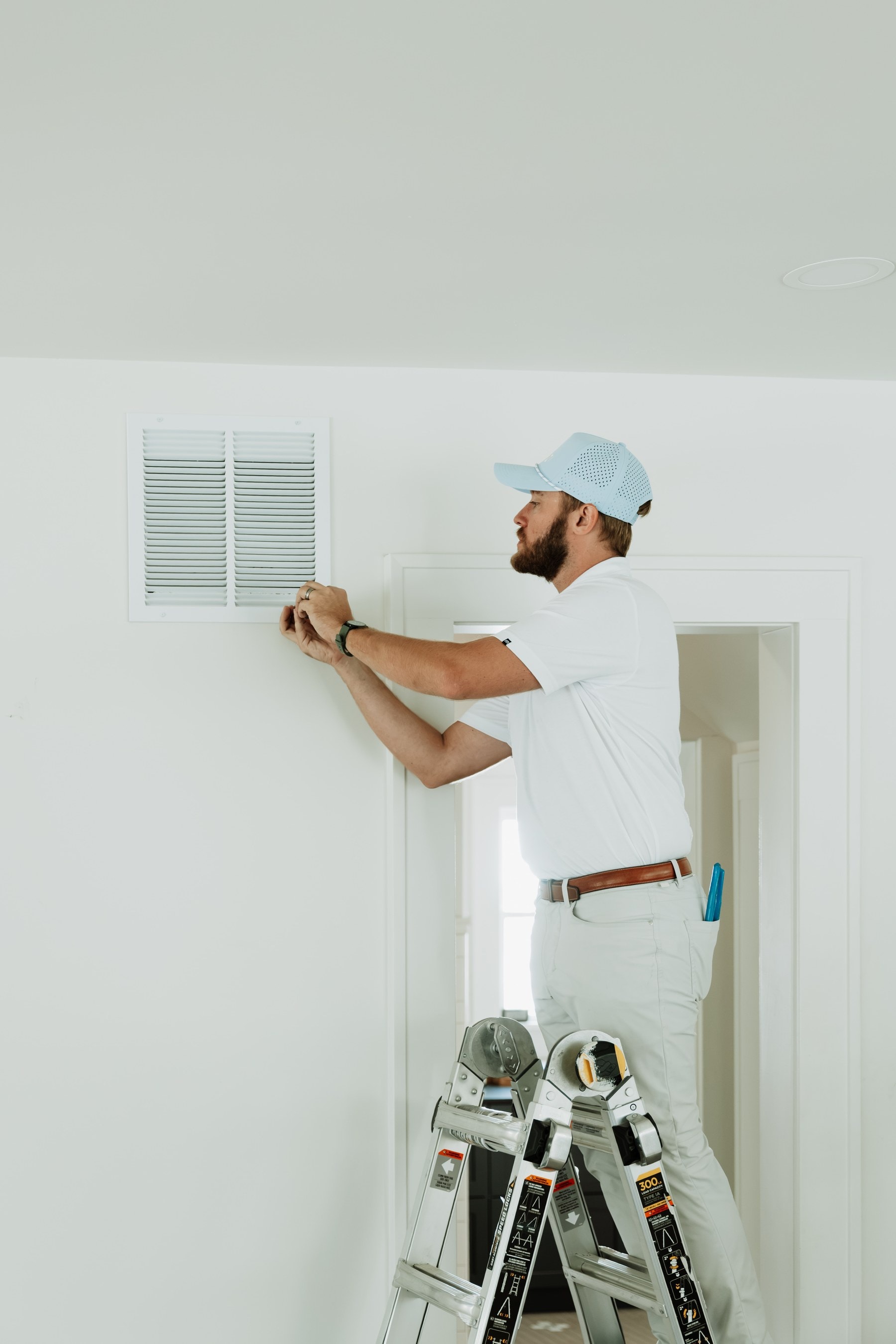 A Brella technician checking a return-air vent